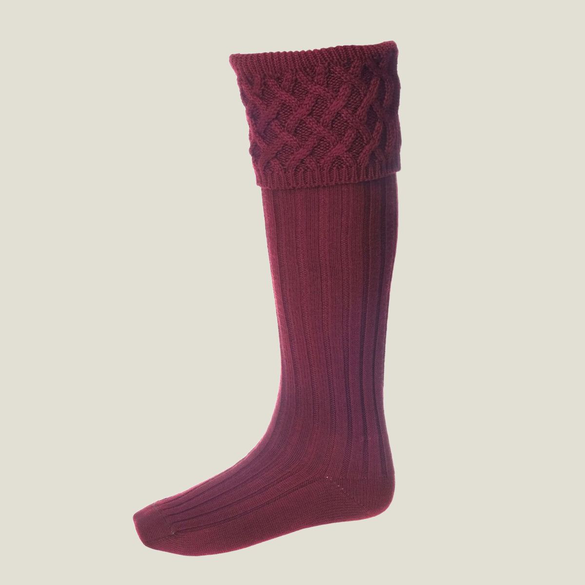 A single knee-high ribbed knit merino wool sock with a textured cable-knit cuff, shown in a deep burgundy or maroon colour against a solid light beige background.