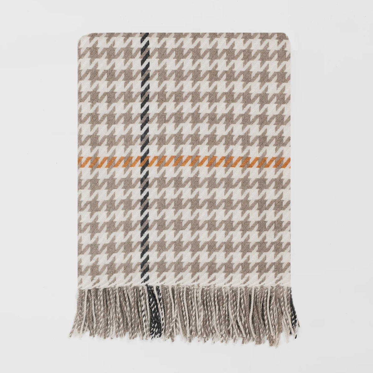 A woven throw blanket with a beige and white houndstooth pattern, featuring a central vertical stripe in black and beige, a horizontal orange stripe, and fringed edges at the bottom, shown against a light grey background.