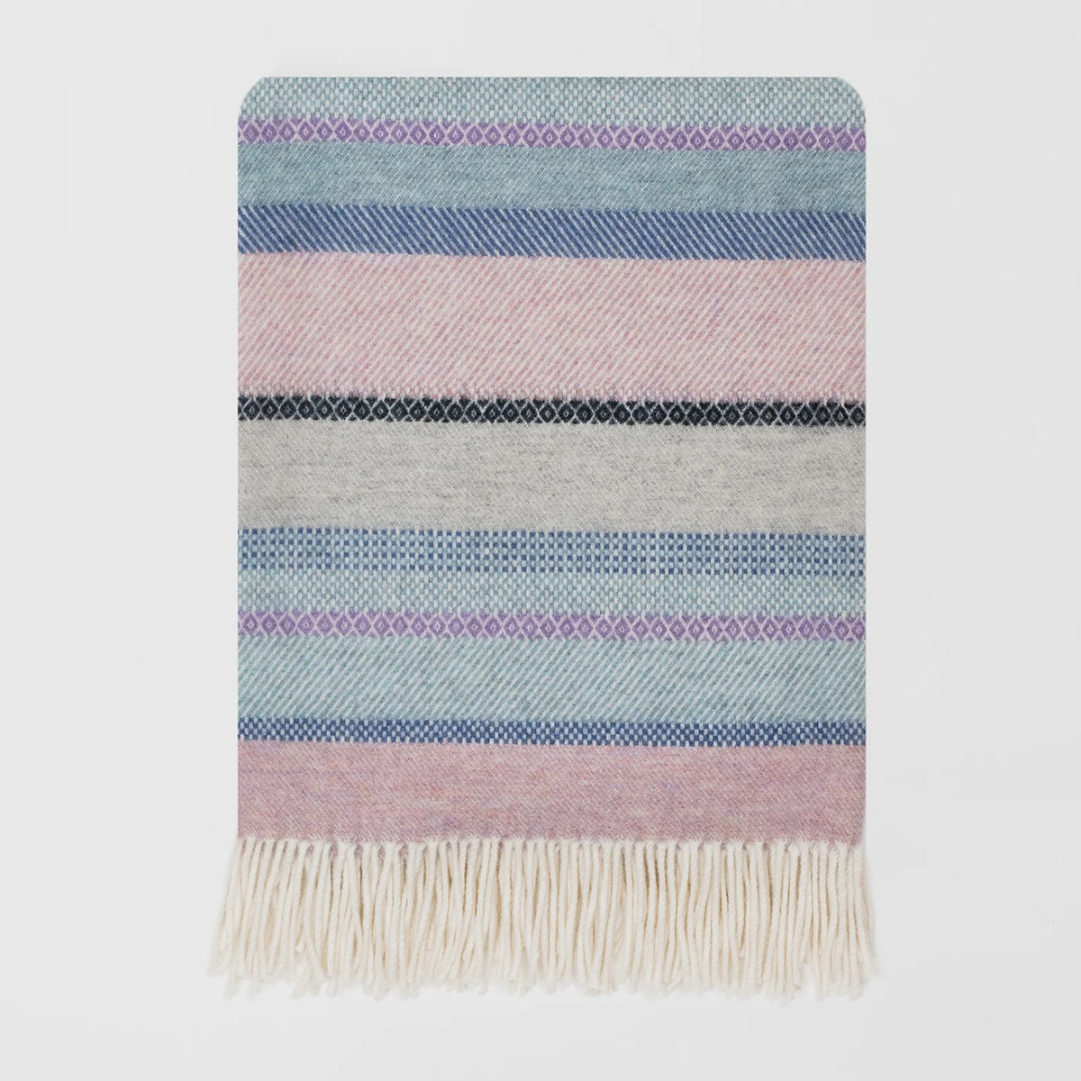 A close up of a woven lambswool merino blanket with a classic fair isle design and a fridge edge.