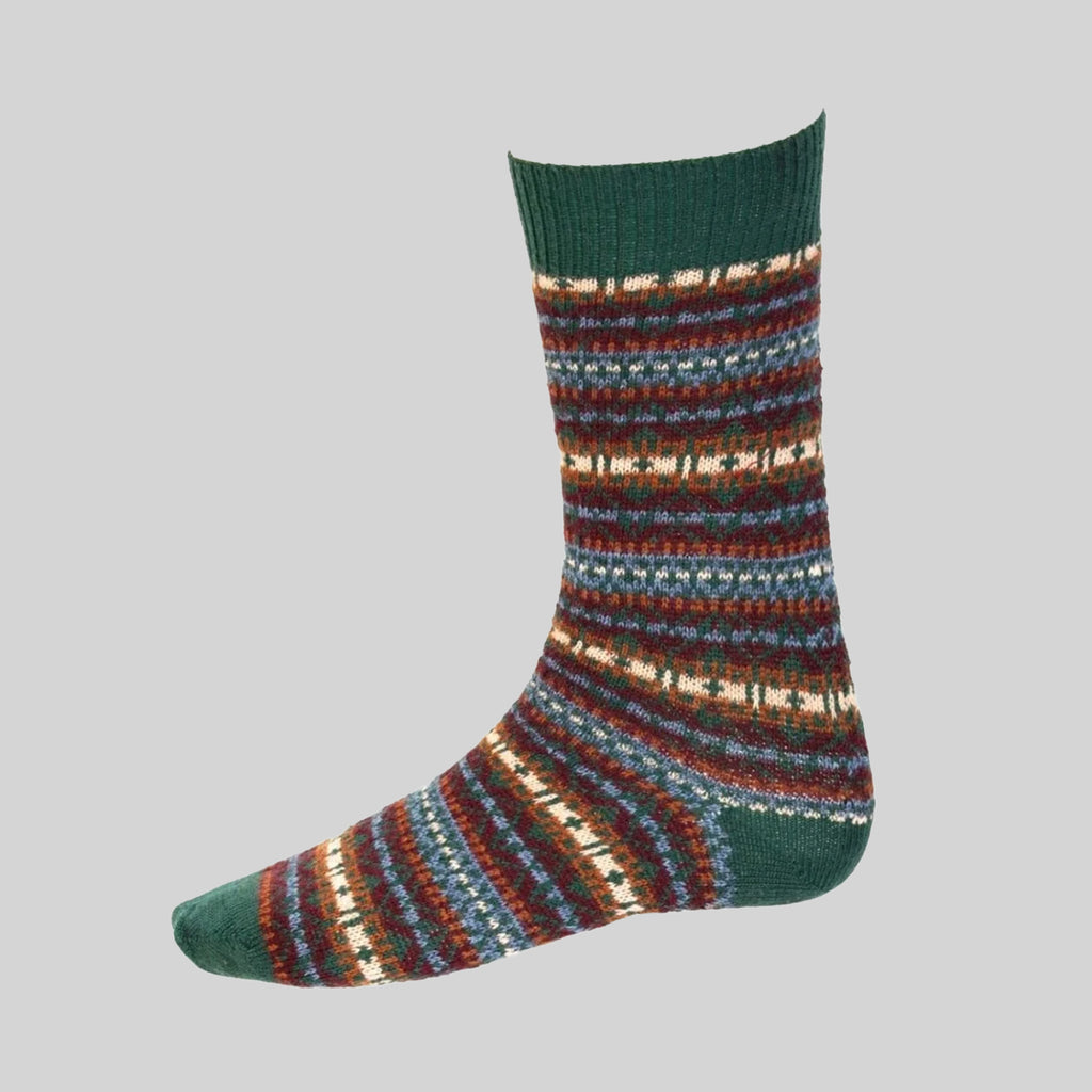 A single crew sock with a multicolor knit fairisle of horizontal stripes in green, blue, red, and cream, featuring solid dark green ribbed cuffs, heel, and toe, shown against a solid gray background.