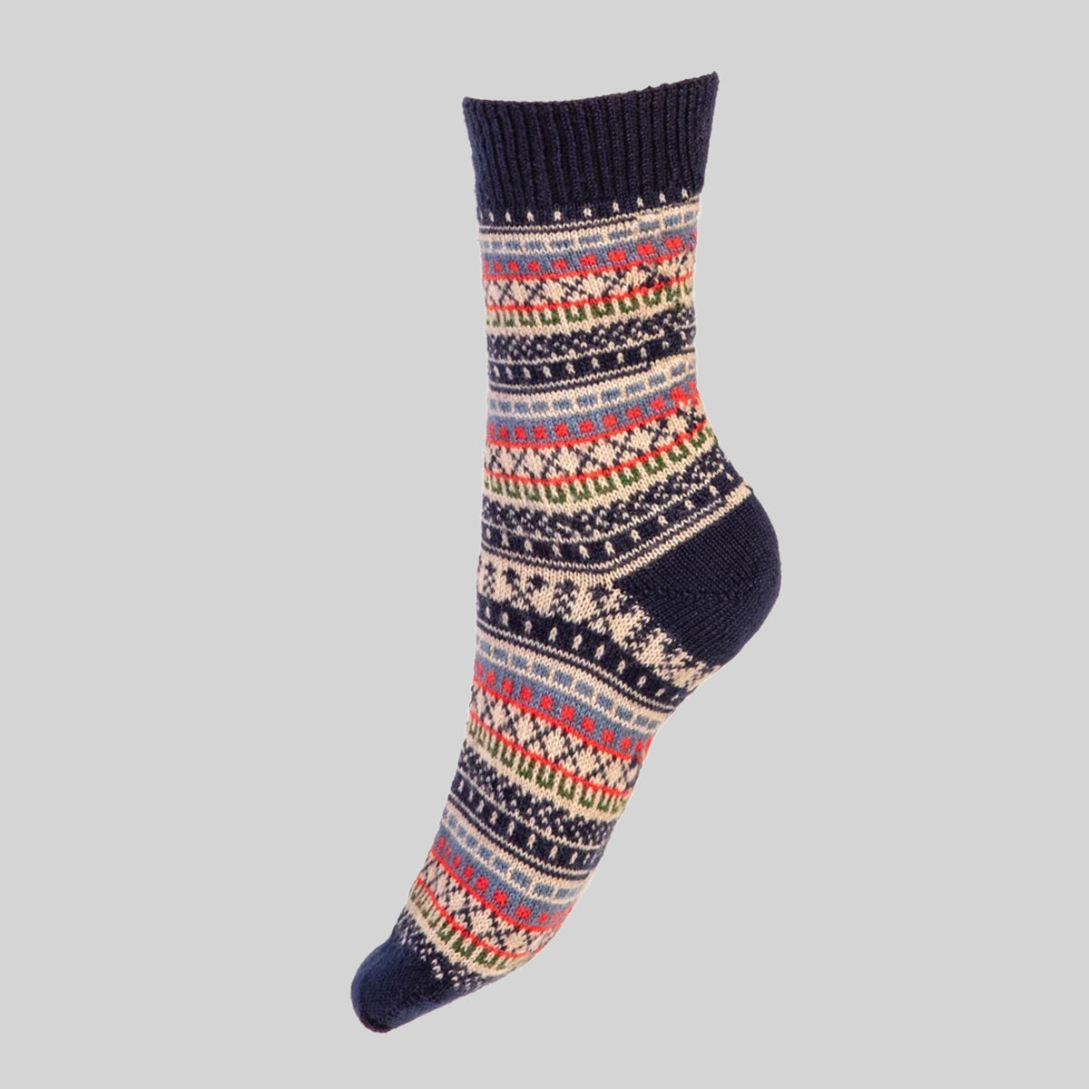 A single crew merino wool sock with a colorful Fair Isle pattern on a dark navy base, shown against a solid light gray background.