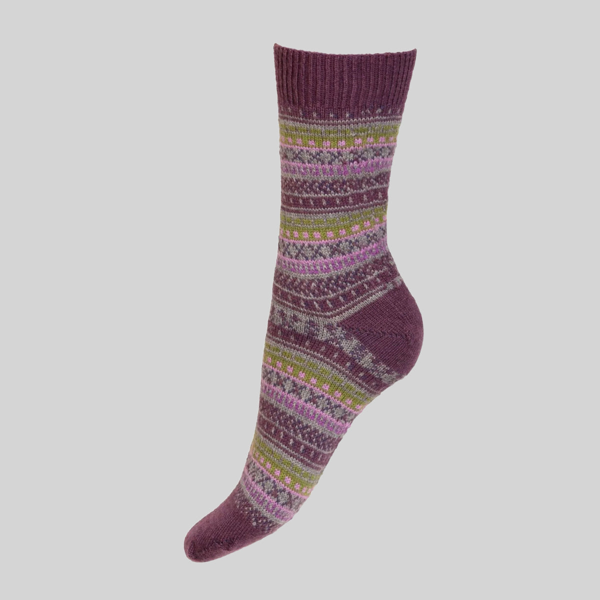A single crew merino sock with a multicolor Fair Isle pattern on a solid dark plum purple base, shown against a neutral light gray background.