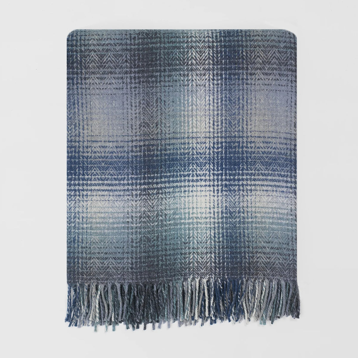 A rectangular woven throw blanket with a blue and gray pattern and fringed edges, shown flat against a light gray background.