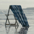 Blue and white merino wool blanket draped on a sea in the sea.