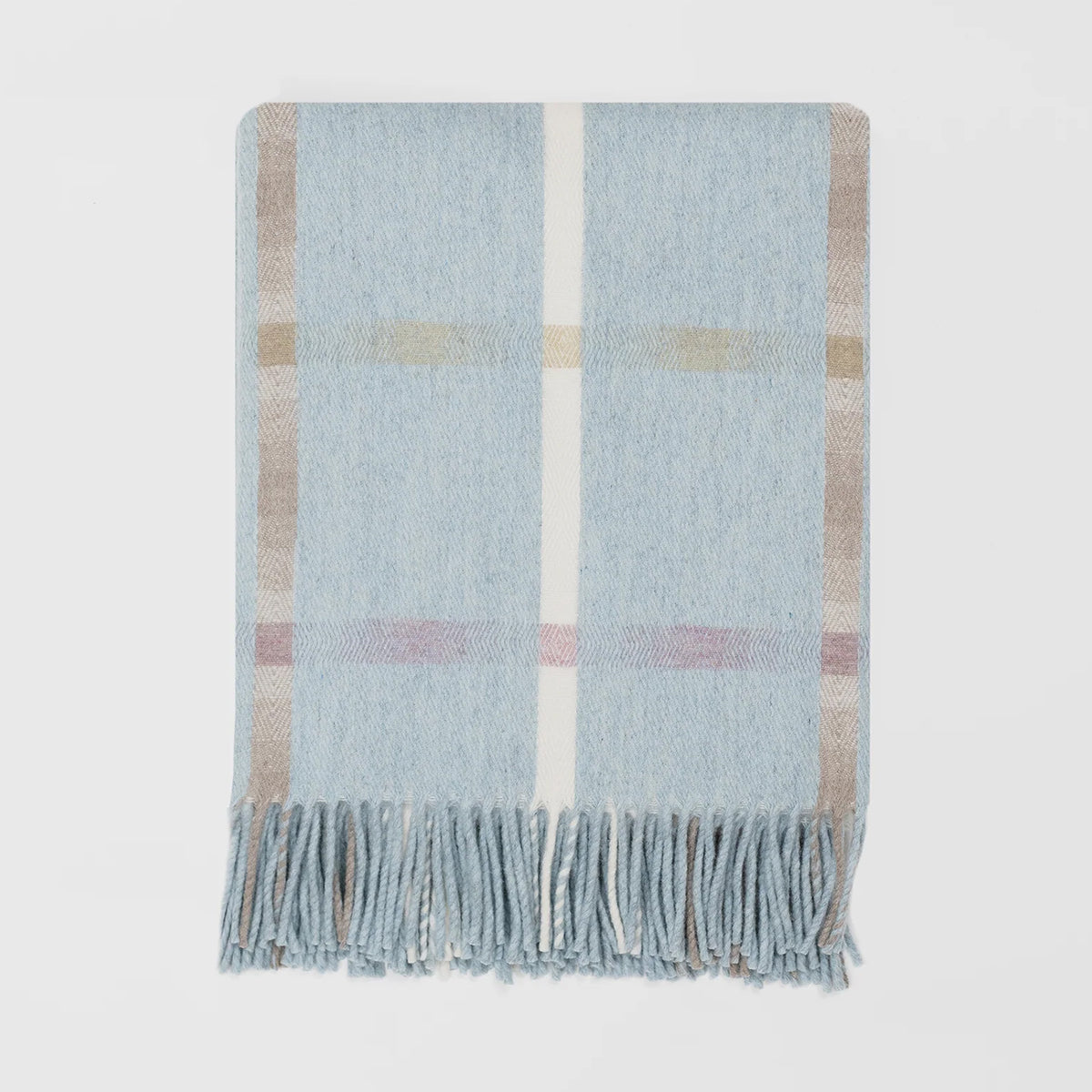 A close up of a merino lambswool Remony throw with a large check design, predominantly in light blue with pink, brown and cream stripes horizontally and vertically.