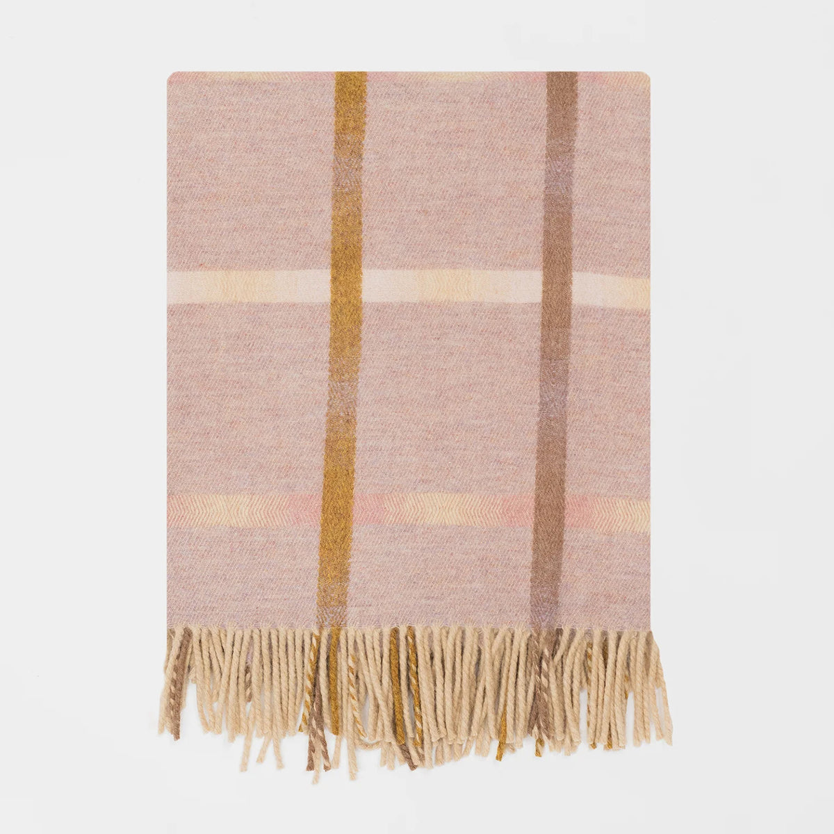 A woven merino throw blanket with a soft pink base, featuring vertical stripes in warm orange and brown tones and horizontal stripes in cream, finished with a fringed hem on a plain white background.