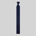 Blue patterned merino tie on a plain grey background.