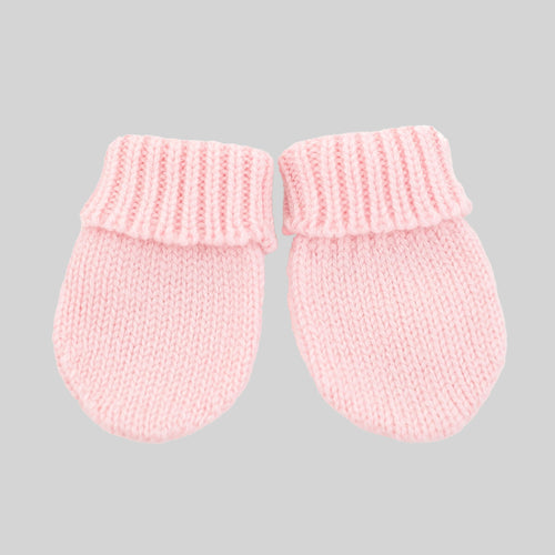 A pair of light pink knit baby mittens with ribbed cuffs, shown on a solid light gray background.