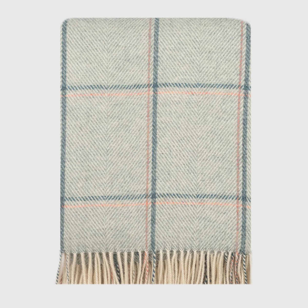 A folded woven throw blanket with a herringbone pattern in green hue, featuring a subtle plaid design with thin blue and pink lines, finished with fringed edges.