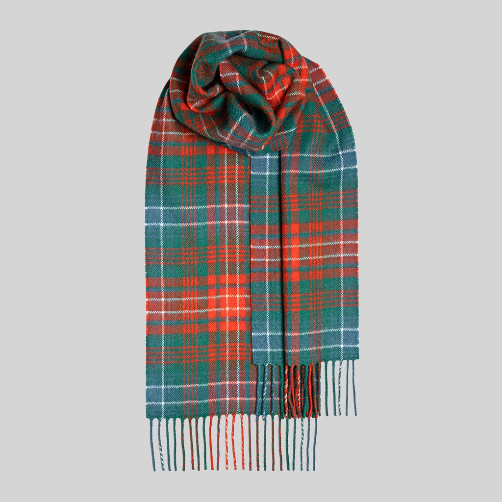A classic tartan scarf in red and black-based tartan with colourful yellow overchecks, draped to show its fringed ends against a solid gray background.